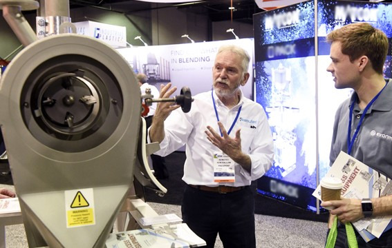 Company representative discussing their product at IPBS.