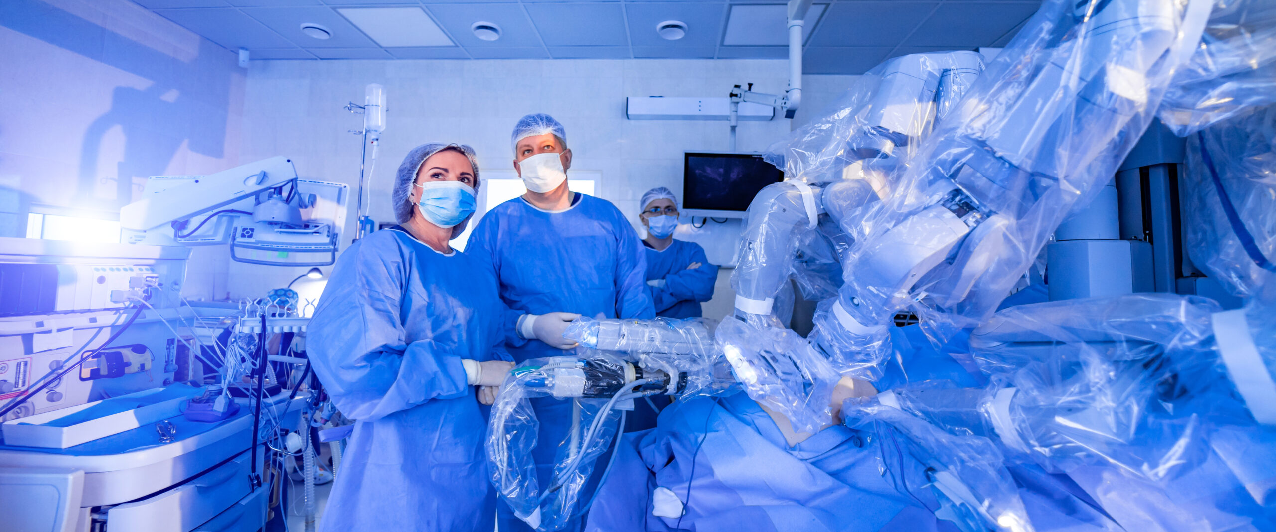Surgeons operating using a surgical robot.